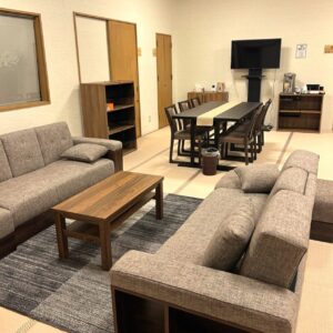 A couch and dining table set in the waiting room at Komorebi Funeral Hall